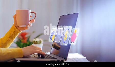 Gros plan d'une personne analysant des données financières sur un ordinateur portable tout en tenant une tasse à café. L'écran affiche diverses icônes financières représentant le niveau global Banque D'Images