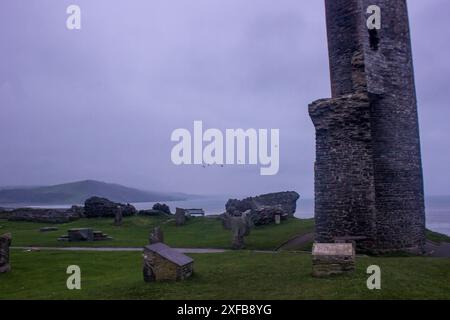 Tôt le matin parmi les vestiges étranges du château d'Aberystwyth avec des oiseaux volant en arrière-plan Banque D'Images