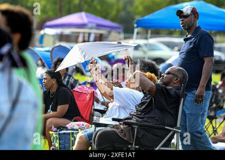 Prattville, Alabama, États-Unis-19 juin 2024 : un couple afro-américain utilisant leurs téléphones cellulaires pour enregistrer les artistes sur scène au Junetenth Celeb Banque D'Images