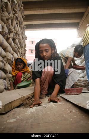 Les enfants ramassent les restes de riz au marché de gros de Badamtoli dimanche, incapables de se payer les produits essentiels à cause de la flambée des prix. 06 avril 2008 Banque D'Images