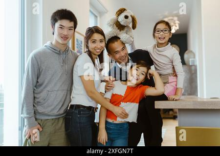 Portrait d'une famille heureuse posant ensemble à la maison Banque D'Images