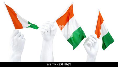 Mains agitant le drapeau de Côte d'Ivoire isolé sur blanc. Rendu 3D. Banque D'Images