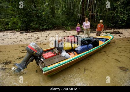 Cheryl Knott, chercheuse orang-outang, avec les enfants Russell et Jessica, avec un bateau chargé, prêt à partir de la station de recherche de Cabang Panti, parc national de Gunung Palung, Bornéo. Sortie du modèle en août 2010. Banque D'Images