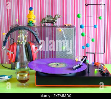 platine vinyle vintage avec disque vinyle violet vieux casque rouge, haut-parleur et objets des années 1970 Banque D'Images