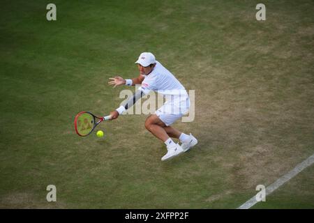 LONDRES, ANGLETERRE - 04 JUILLET : Yoshihito Nishioka du Japon joue un tir dans le match de deuxième tour en simple masculin contre Giovanni Mpetshi Perricard de France lors de la quatrième journée des Championnats de Wimbledon 2024 au All England Lawn Tennis and Croquet Club le 4 juillet 2024 à Londres, Angleterre Banque D'Images