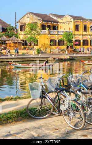 Hoi an (Hoian), Vietnam - 11 avril 2018 : vélos garés près de la rivière Thu bon dans la ville antique de Hoi an. Banque D'Images