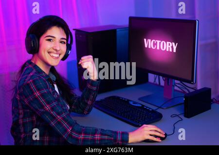 Excité joueur célébrant la victoire après la session de jeu à l'ordinateur Banque D'Images