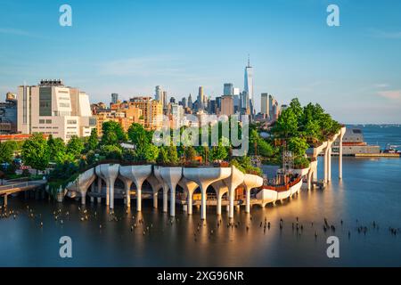 Longue exposition de Little Island au-dessus de la rivière Hudson à Chelsea, New York, avec la ligne d'horizon inférieure de Manhattan comme toile de fond magnifique au crépuscule. Banque D'Images