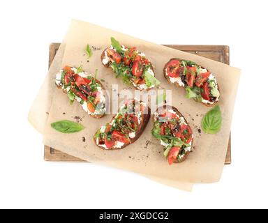 Délicieuse ricotta bruschettas avec tomates, roquette et basilic isolé sur blanc, vue de dessus Banque D'Images