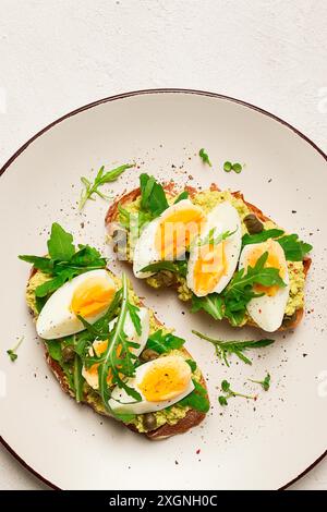 Sandwich à la purée d'avocat, oeuf dur, et roquette, sur pain, fait maison, petit déjeuner Banque D'Images