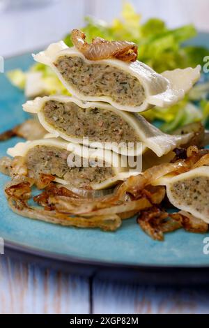 Moitiés de pâtes souabes maultaschen avec salade Banque D'Images