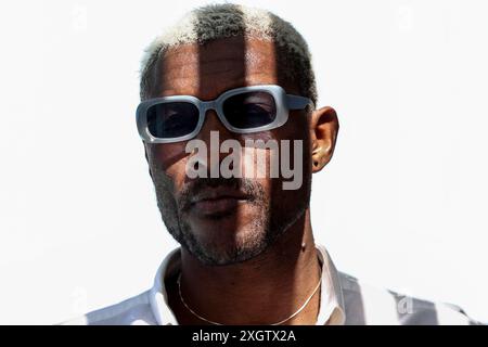 Portrait en gros plan d'un homme noir mature portant des lunettes de soleil blanches et regardant loin de l'appareil photo. Il a les cheveux blonds courts et un express confiant Banque D'Images