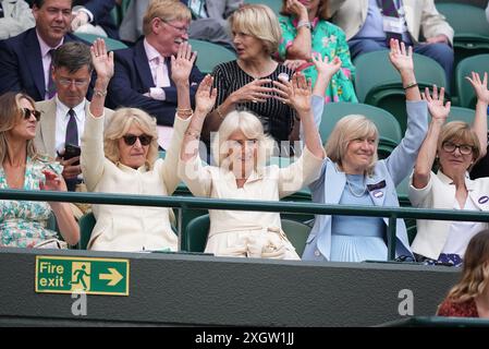 Queen Camilla (au centre), Annabel Elliot (à gauche) et Debbie Jevans, présidente du All England Lawn Tennis Club, participent à une vague à court One le dixième jour des Championnats de Wimbledon 2024 au All England Lawn Tennis and Croquet Club, Londres. Date de la photo : mercredi 10 juillet 2024. Banque D'Images