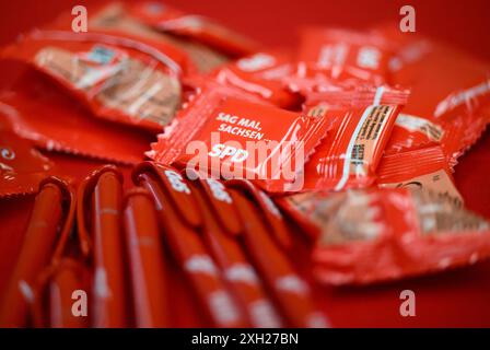 Dresde, Allemagne. 11 juillet 2024. Des stylos et des bonbons avec le logo du SPD reposent sur une table lors de la présentation de la campagne pour les élections d'État en Saxe dans la maison Herbert Wehner. Crédit : Robert Michael/dpa/Alamy Live News Banque D'Images