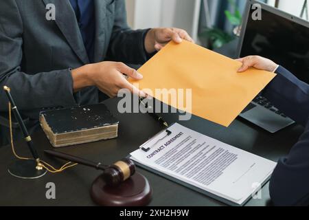 le client rencontre un avocat au sein du bureau du conseiller juridique pour demander des conseils sur la loi et les poursuites qui seront déposées afin d'obtenir un avantage Banque D'Images