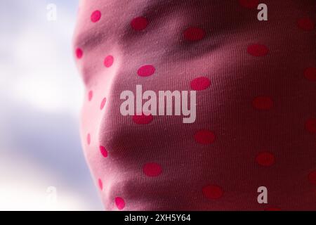 Close up of woman wearing pink mask with many points Banque D'Images