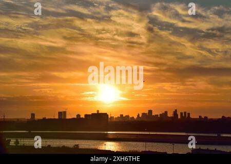 Royal Docks Simmer Sunset - une vue vers le nord à travers Newham vers Stratford Banque D'Images