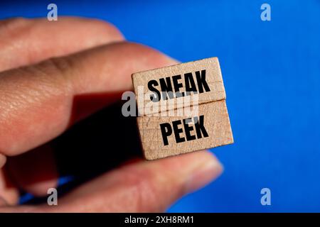 Sneak Pek message écrit sur des blocs de bois avec fond bleu. Symbole conceptuel Sneak Pek. Copier l'espace. Banque D'Images