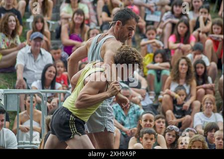 Viladecasn, ESPAGNE - 12 JUILLET 2024 : deux athlètes se soutiennent mutuellement lors d'un événement sportif, capturant un moment de coopération et d'esprit sportif. Banque D'Images