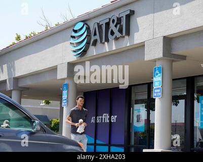 San Bruno, États-Unis. 12 juillet 2024. Un homme passe devant un magasin AT&T à San Bruno, Californie, États-Unis, le 12 juillet 2024. Un pirate informatique a accédé et téléchargé les données des appels et des SMS de presque tous les clients AT&T Wireless, a révélé la société dans un dépôt de titres vendredi. Crédit : Li Jianguo/Xinhua/Alamy Live News Banque D'Images