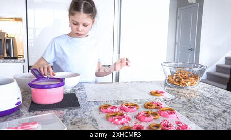 Le jeune chef prépare des friandises recouvertes de chocolat au Sunny Kitchen Banque D'Images