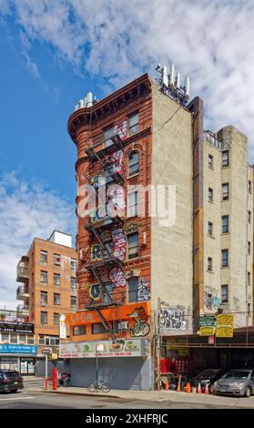 Quartier chinois de New York : L'architecte M. Bernstein a utilisé une tourelle pour tourner le coin pointu de 88 Division Street/2-6 Eldridge Street, un immeuble de six étages. Banque D'Images