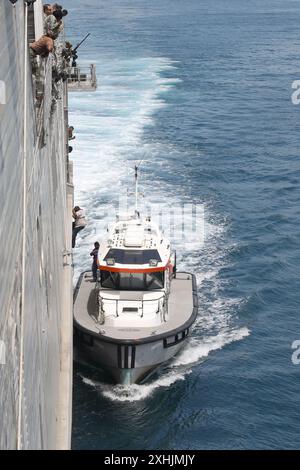 KINGSTON, Jamaïque (13 juillet 2024) des marins, affectés au navire de transport rapide expéditionnaire de classe Spearhead USNS Burlington (T-EPF 10), regardent un pilote jamaïcain monter à bord du bateau du pilote après avoir aidé à guider Burlington hors des quais de Kingston à Kingston, en Jamaïque, dans le cadre de Promise 2024. La promesse continue 2024 contribue à renforcer l'état de préparation des partenaires des Caraïbes et de l'Amérique latine face aux menaces malveillantes dans la région. (Photo de l'US Navy par Adriones Johnson, spécialiste des communications de masse, 2e classe) Banque D'Images