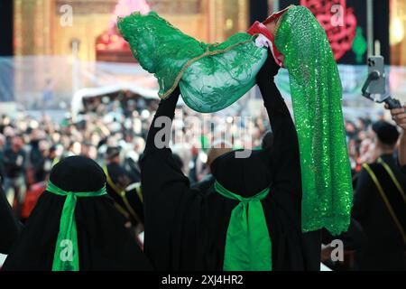 Karbala, Irak. 16 juillet 2024. Les musulmans chiites irakiens participent à une procession religieuse le jour de l'Achoura, le dixième jour du mois de Mouharram. Mouharram est considéré comme un mois de deuil et de souvenir pour les musulmans chiites du monde entier, au cours duquel ils commémorent le martyre du petit-fils du prophète islamique Mahomet Husayn ibn Ali, tué lors de la bataille de Karbala au VIIe siècle. Crédit : Ameer Al-Mohammedawi/dpa/Alamy Live News Banque D'Images