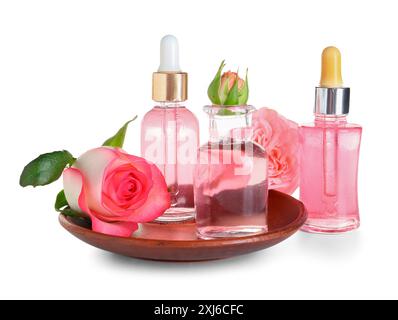 Assiette et bouteilles d'huile cosmétique avec extrait de rose sur fond blanc Banque D'Images