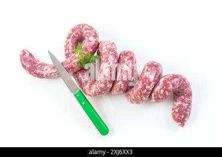 Saucisse brute de Toulouse et couteau sur fond blanc Banque D'Images