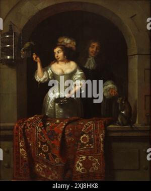 Une dame avec un perroquet et un gentleman avec un singe - Caspar Netscher Banque D'Images
