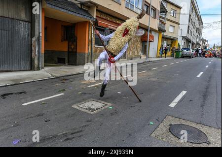 Un Sidro, un masque traditionnel de Valdesoto dans les Asturies, en Espagne, prend vie pendant le festival Mazcaraes d'Iviernu. Brandissant un long poteau, le Sidro utilise cet outil symbolique pour interagir avec la foule et chasser les mauvais esprits, incarnant le riche folklore et le patrimoine culturel au cœur des célébrations hivernales. Banque D'Images