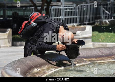 Une vague de chaleur prolongée approche du pic à Athènes Un touriste tente de se rafraîchir à une fontaine de la place Syntagma alors qu'une vague de chaleur prolongée approche du pic à Athènes. Athènes Grèce Copyright : xNicolasxKoutsokostasxNicolasxKoutsokostasx DSC 202407170087 Banque D'Images