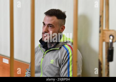 Pétersbourg, Russie. 17 juillet 2024. Le citoyen allemand Patrick Schobel, soupçonné de trafic de drogue, est assis dans la cage de l'accusé dans une salle d'audience de Saint-Pétersbourg. Patrick Schobel a été arrêté à l’aéroport de Pulkovo pour avoir transporté des bonbons gommeux contenant du cannabis. Crédit : SOPA images Limited/Alamy Live News Banque D'Images