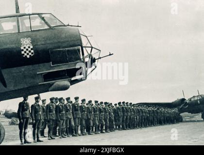 Une photographie montre des soldats croates en formation sur un aérodrome pendant l'opération Barbarossa en 1941. Après l'invasion de la Yougoslavie par l'axe, le nouvel État indépendant de Croatie s'est aligné sur l'Allemagne nazie. Les troupes croates, motivées par l'alignement idéologique et l'intérêt personnel, ont soutenu l'avancée allemande contre les forces soviétiques sur le front de l'est. Banque D'Images