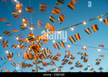 Drapeaux colorés et lumières pendant la foire traditionnelle à Fuenteheridos, Huelva, Andalousie, Espagne mettant en valeur l'esprit festif et la culture locale. Banque D'Images