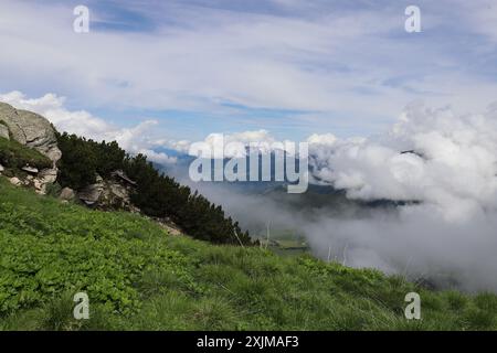 Le brouillard matinal dérive devant le plateau de l'Ahorn dans les Alpes du Zillertal et empêche la vue sur la vallée Banque D'Images