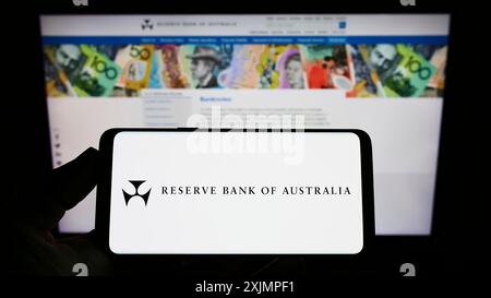 Stuttgart, Allemagne, 10-01-2022 : personne tenant un smartphone avec le logo de l'émetteur Reserve Bank of Australia (RBA) sur l'écran devant le site Web. Concentrez-vous sur Banque D'Images