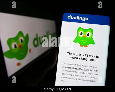 Stuttgart, Allemagne, 01-07-2023 : personne tenant le téléphone portable avec la page Web de la société de technologie éducative Duolingo Inc. sur l'écran avec le logo. Concentrez-vous sur Banque D'Images
