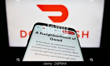 Stuttgart, Allemagne, 07-25-2023, smartphone avec le site Web de la société américaine de livraison de nourriture DoorDash Inc. sur l'écran devant le logo de l'entreprise. Concentrez-vous sur Banque D'Images