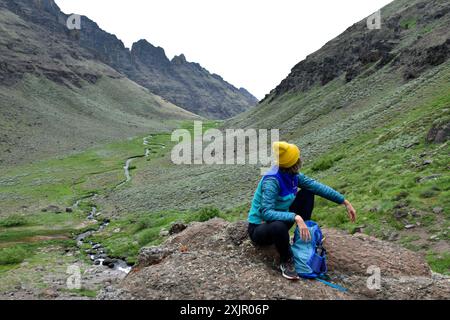 Une femme randonneuse surplombant Wildhorse Creek dans la région de Steens Mountain Wilderness, comté de Harney, Oregon, États-Unis. Banque D'Images