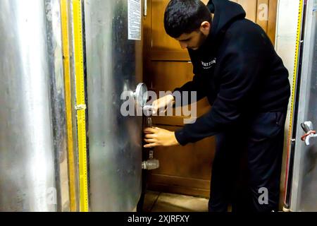 Un vigneron verse Wine, Midin Şarapçılık Winery Southeastern Turkey, réservoirs de vin, installation de réservoir de vin Banque D'Images