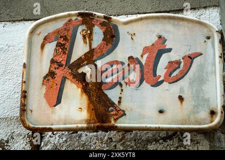 Signe en métal rouillé avec Resto écrit en rouge et noir Banque D'Images