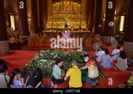 Bangkok, Thaïlande. 13 juillet 2024. Les bouddhistes offrent des fleurs aux moines. A l'occasion du Carême bouddhiste, au Wat Debsirindrawas Ratchaworawihan à Bangkok, Thaïlande, le 21 juillet 2024. Représente le point de départ du Carême bouddhiste est le moment où les moines sont tenus de rester dans les temples pendant la saison des pluies pour étudier le dhamma et pratiquer la méditation pendant une période de trois mois. (Photo de Teera Noisakran/Sipa USA) crédit : Sipa USA/Alamy Live News Banque D'Images