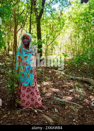 Zanzibar, Tanzanie - janvier 2021: Portrait d'une belle femme africaine dans un masque coloré contre Covid 19 sur son visage. Afrique Banque D'Images