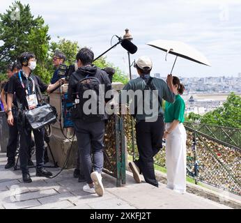 Paris, France 07.22.2024. Une équipe de caméras interviewe une dame dans les escaliers de Montmartre, et rend compte des prochains Jeux Olympiques à Paris Banque D'Images