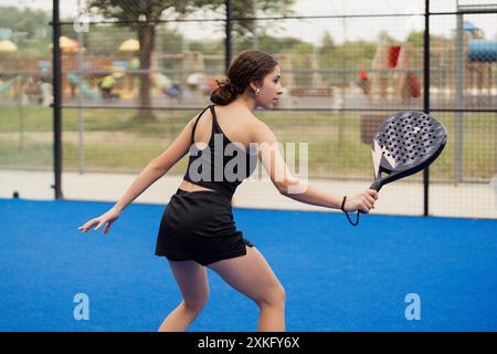 Femme jouant au padel sur un court extérieur Banque D'Images