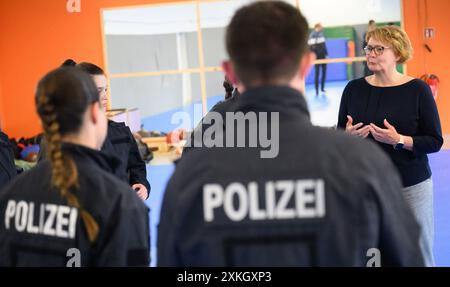 Hanovre, Allemagne. 23 juillet 2024. Daniela Behrens (SPD), ministre de l’intérieur de basse-Saxe, s’entretient avec des stagiaires commissaires de police au centre de formation du département de police de Hanovre. Les policiers sont formés pour arrêter des personnes armées de couteaux. Au cours de son voyage d'été, la ministre de l'intérieur de basse-Saxe, Behrens (SPD), a visité le centre de formation et a de nouveau appelé à l'interdiction des couteaux dans la circulation locale. Les zones d'interdiction des armes doivent également être étendues. Crédit : Julian Stratenschulte/dpa/Alamy Live News Banque D'Images