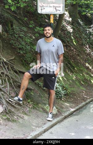 Une image vibrante représentant un jeune homme tatoué en vêtements de sport, profitant d'une journée ensoleillée dans la ville de Zurich. Parfait pour les thèmes liés à la Li urbaine Banque D'Images