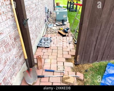 Réparation d'un poteau de clôture à l'aide d'outils et de finisseurs de briques Banque D'Images